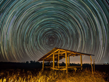 Built structure on field against sky at night