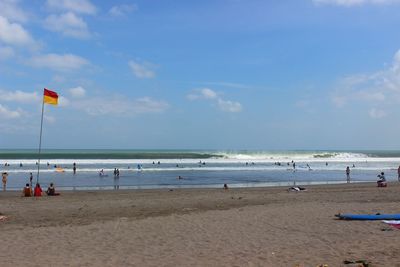 People on beach against sky