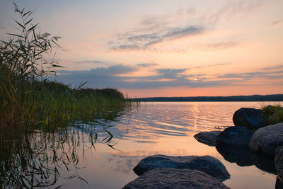 Scenic view of lake against sky during sunset