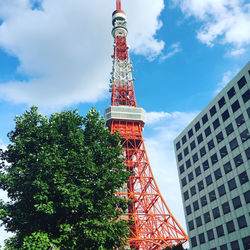 Low angle view of tower and buildings against sky