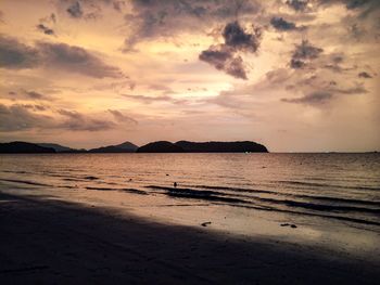 Scenic view of beach against sky during sunset