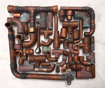 Directly above shot of rusty pipes arranged on table