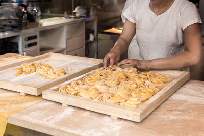 Midsection of man preparing food in kitchen