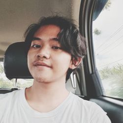 Portrait of young man in car