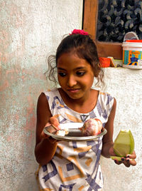 Portrait of a smiling girl holding food
