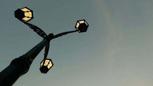 Low angle view of street light against sky