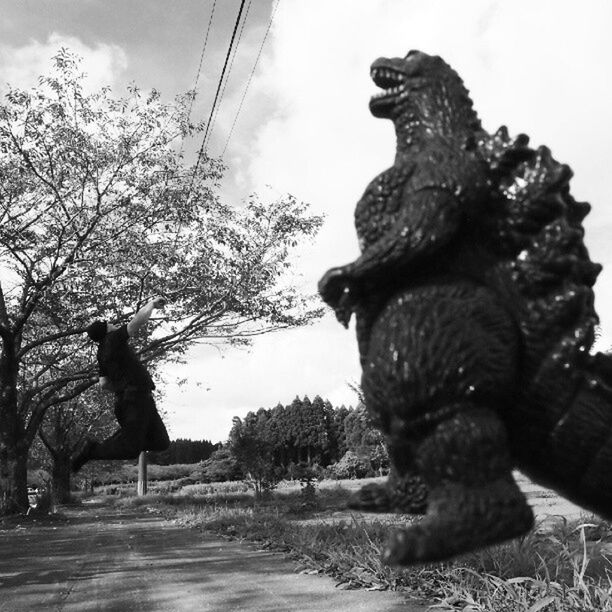 animal themes, one animal, tree, mammal, sky, full length, domestic animals, dog, sitting, pets, day, monkey, sculpture, wildlife, statue, outdoors, two animals, sunlight, animals in the wild, standing