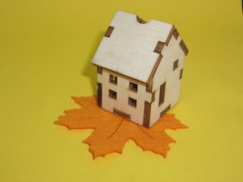 High angle view of paper toy against yellow background