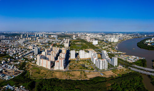 High angle view of buildings against blue sky