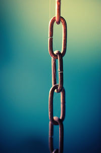 Close-up of chain against wall