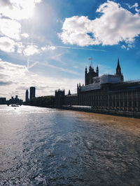 Palace of westminster by thames river in city