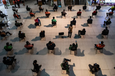 High angle view of people walking on tiled floor