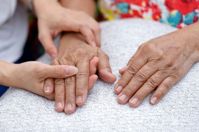 Midsection of couple holding hands