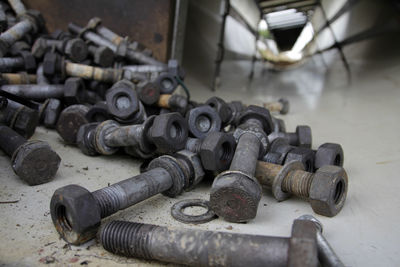 Close-up of rusty nut bolts on table