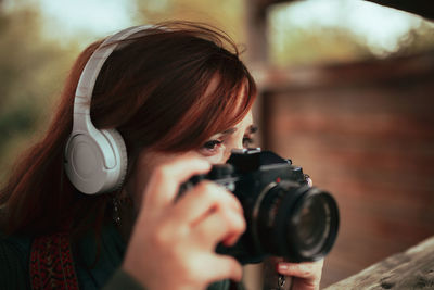 Close-up of woman photographing outdoors