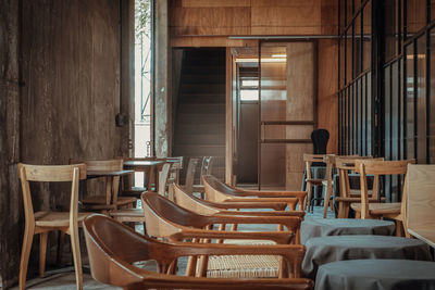 Empty chairs and tables in room