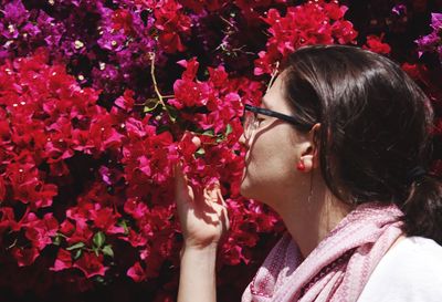 Woman smelling flowers in garden