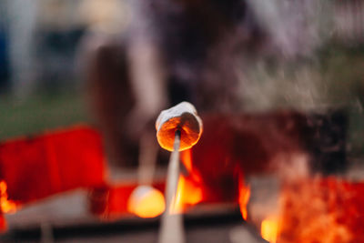 Close-up of lit candle against blurred background