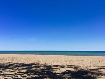 Scenic view of beach against clear sky