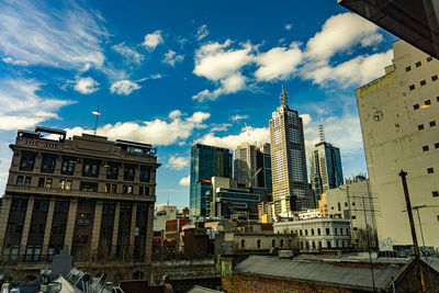 Low angle view of buildings against cloudy sky