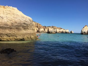 Scenic view of sea against clear blue sky