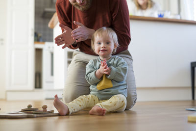 Portrait of cute baby boy sitting at home