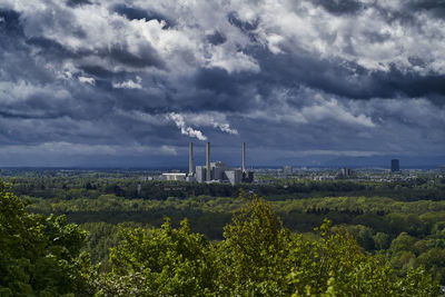 View of factory against cloudy sky