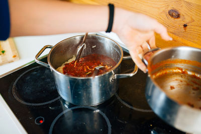 Cropped hand of woman preparing food