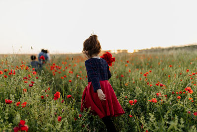 Mother with children picking poppies