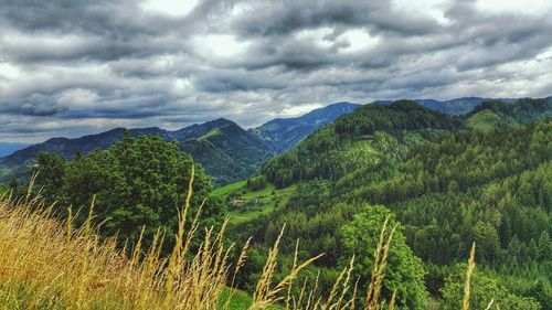 Scenic view of mountains against cloudy sky