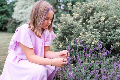 Young woman standing amidst plants