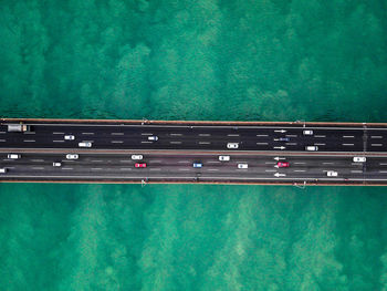 Directly above shot of cars on bridge over sea