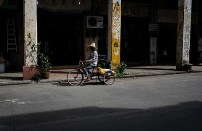 Man cycling on bicycle in city