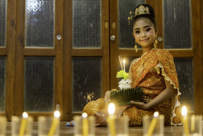 View of lit candles in temple