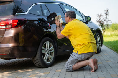 Low section of man washing car