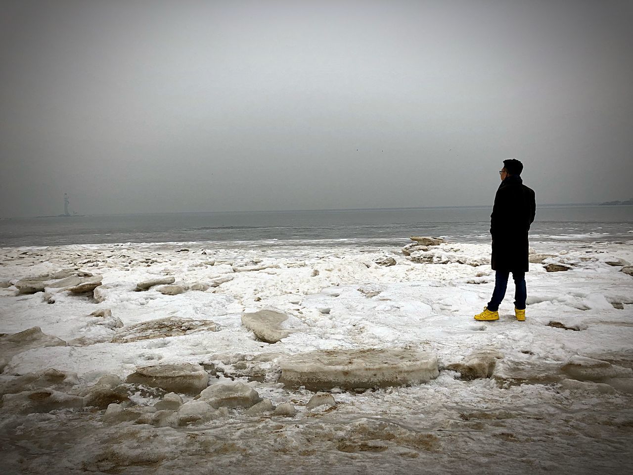 sea, beach, standing, one person, full length, nature, tranquility, beauty in nature, scenics, outdoors, real people, water, sky, men, horizon over water, day, one man only, adult, only men, adults only, people