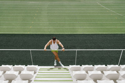 Athlete doing warm up exercise on running track