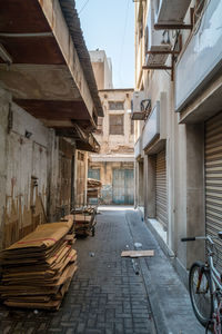 Stack of corrugated cardboards on street by old buildings