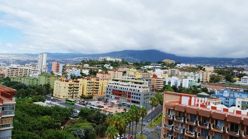 High angle view of cityscape against cloudy sky