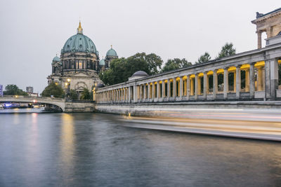 Bridge over river with buildings in background