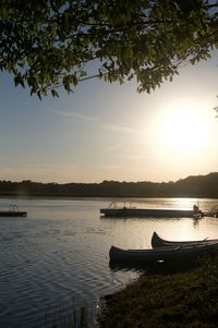 Silhouette of boat in lake during sunset