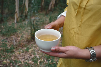 Midsection of woman holding drink