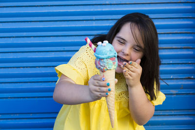 Teenager girl with down syndrome enjoying an ice cream