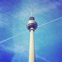 Low angle view of tower against cloudy sky