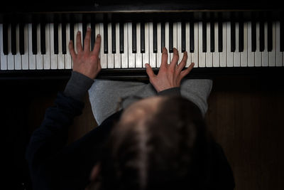 High angle view of woman playing piano