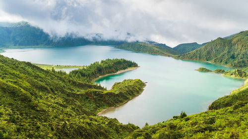 Scenic view of lake and mountains against sky