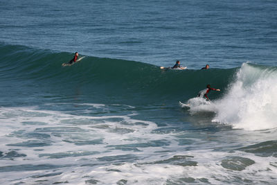 People surfing in sea