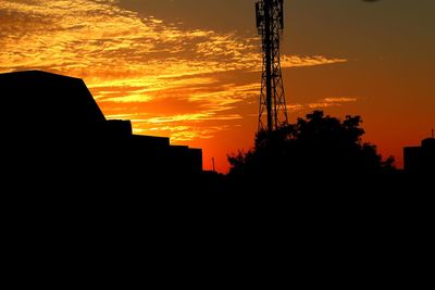 Silhouette tower against sky during sunset