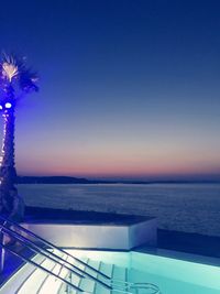 Scenic view of sea against clear blue sky at night