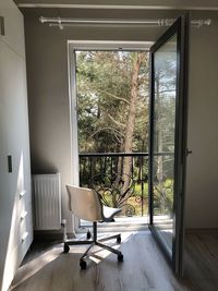 Empty chair by window at home